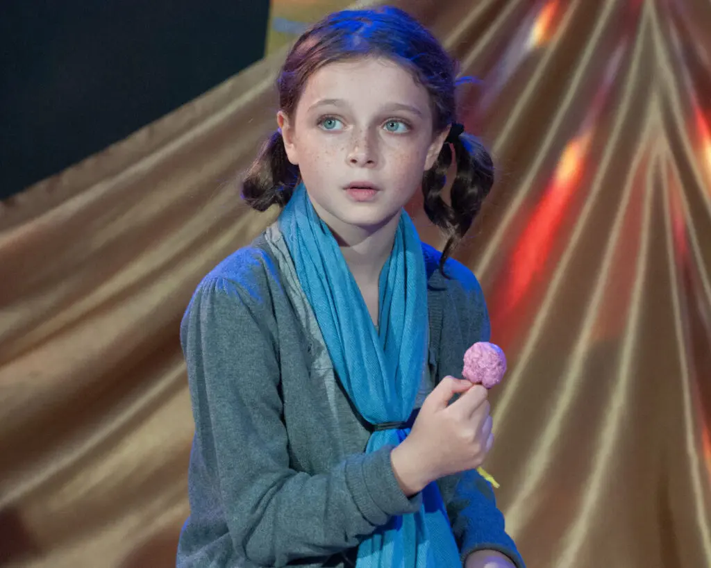 a girl holding a candy
