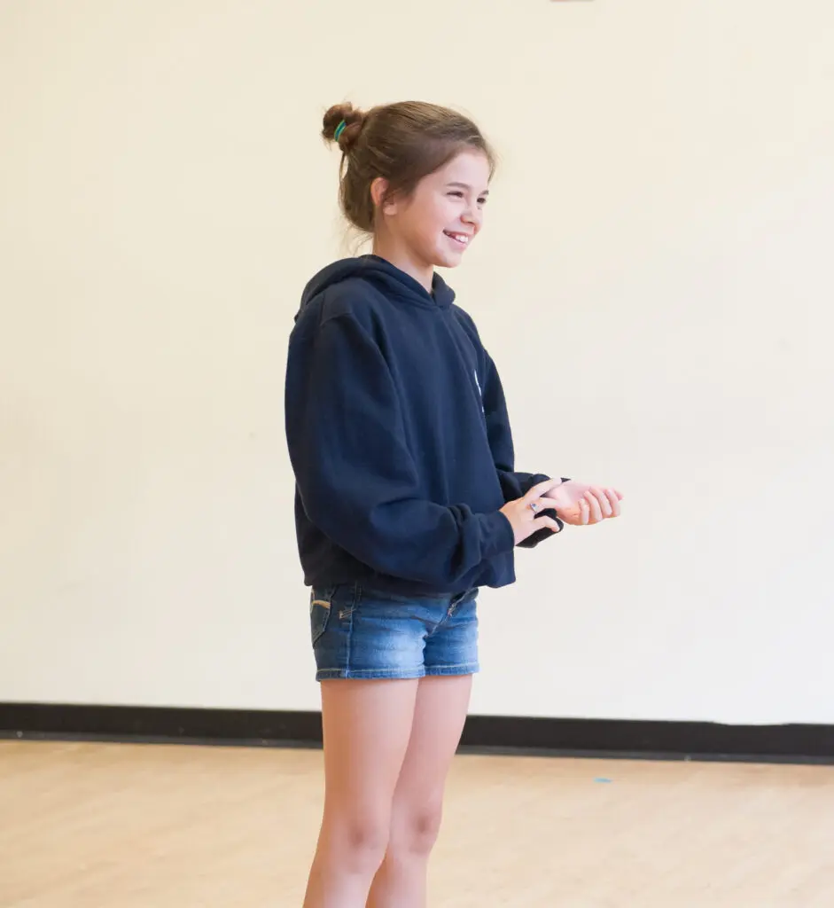 a girl standing in a room