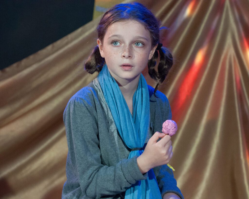 a girl holding a candy