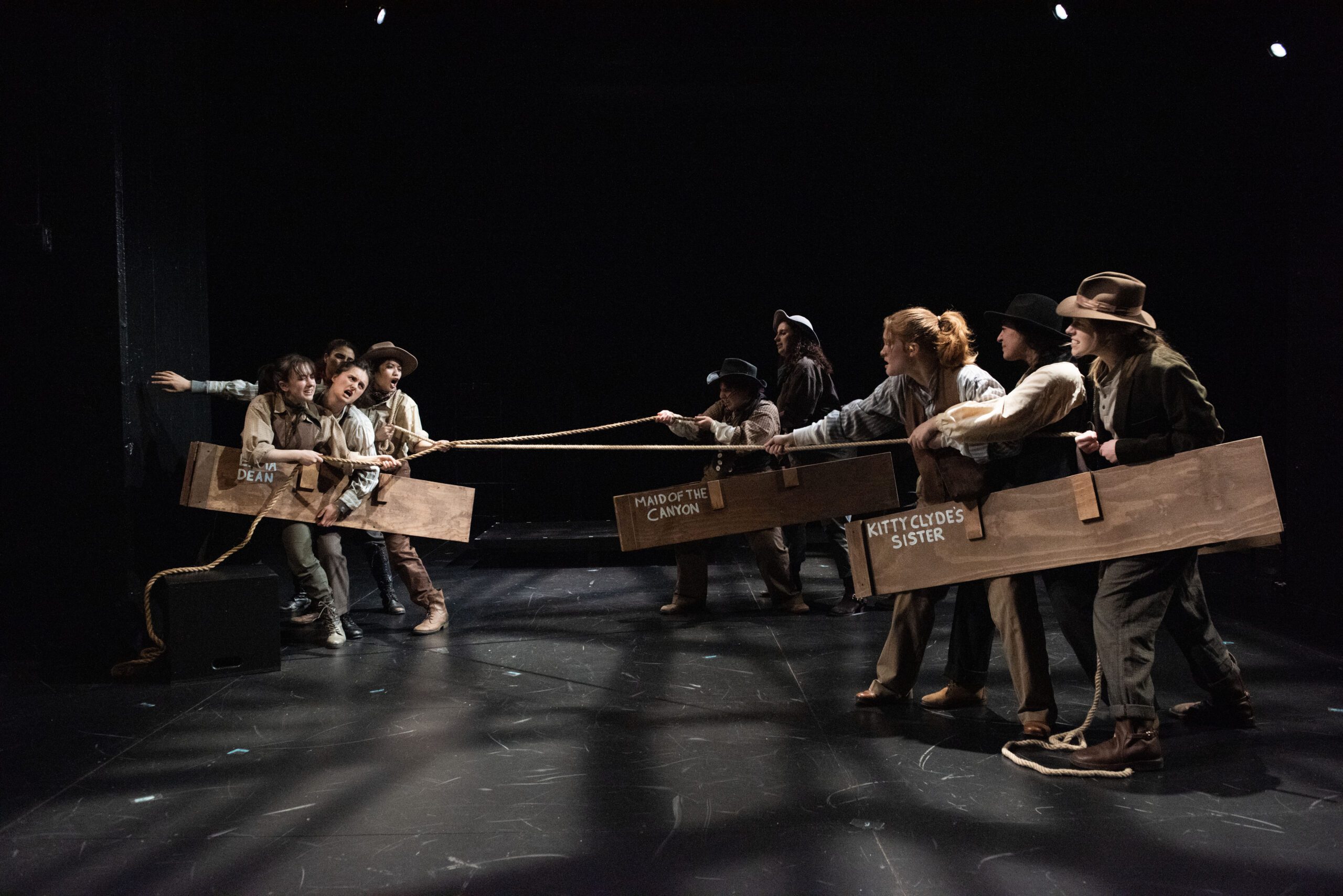 a group of people holding wooden boards