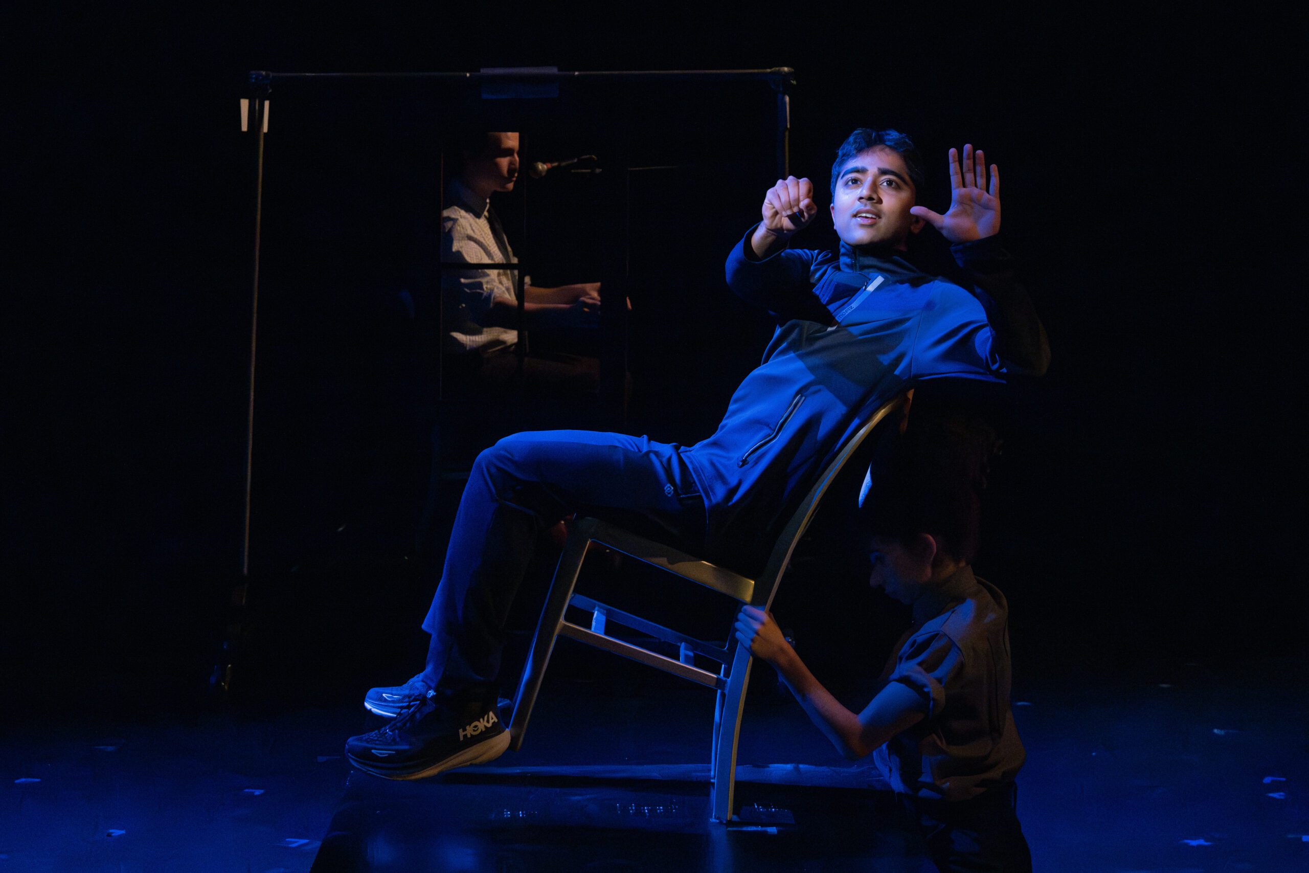 a man sitting in a chair with his hands up