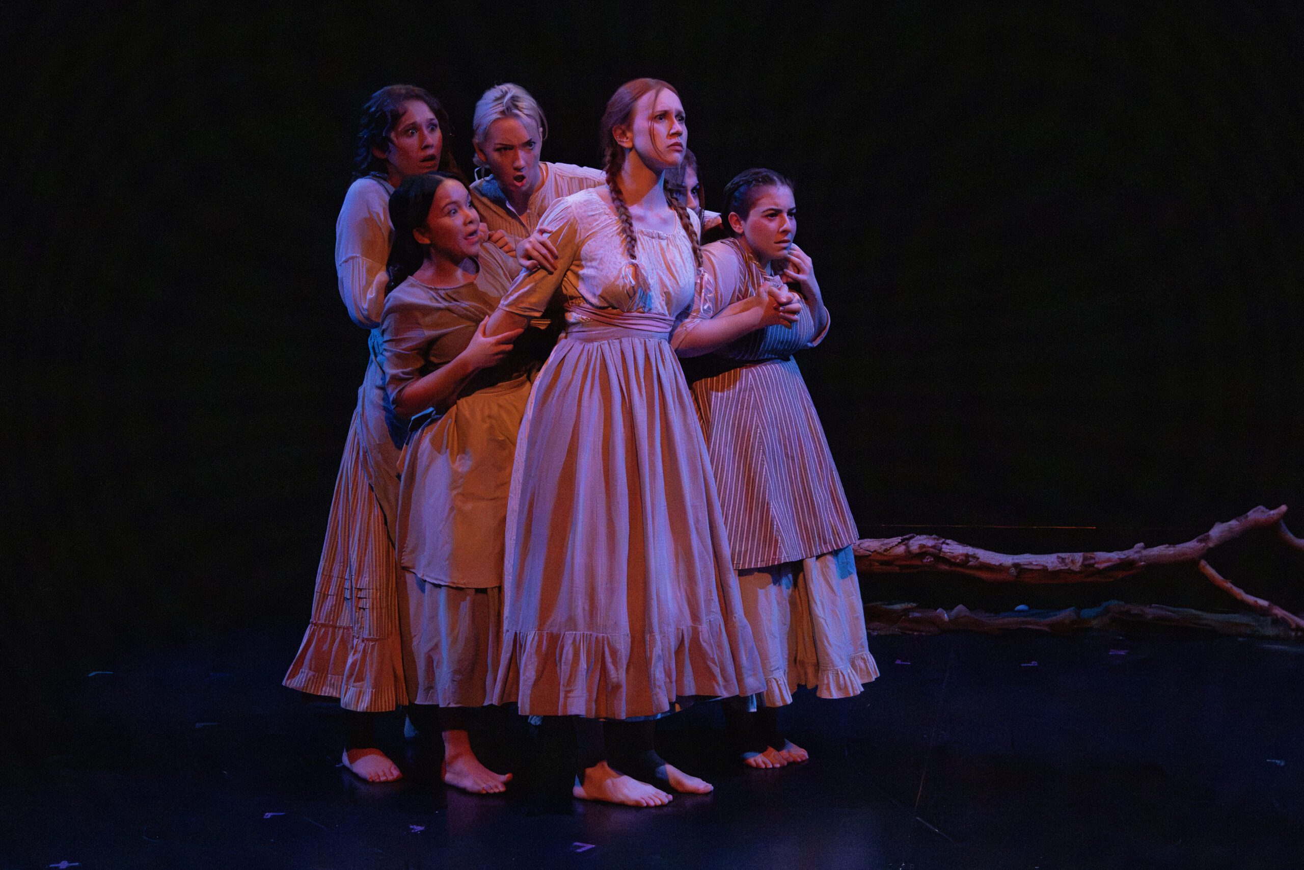 a group of women in dresses on a stage