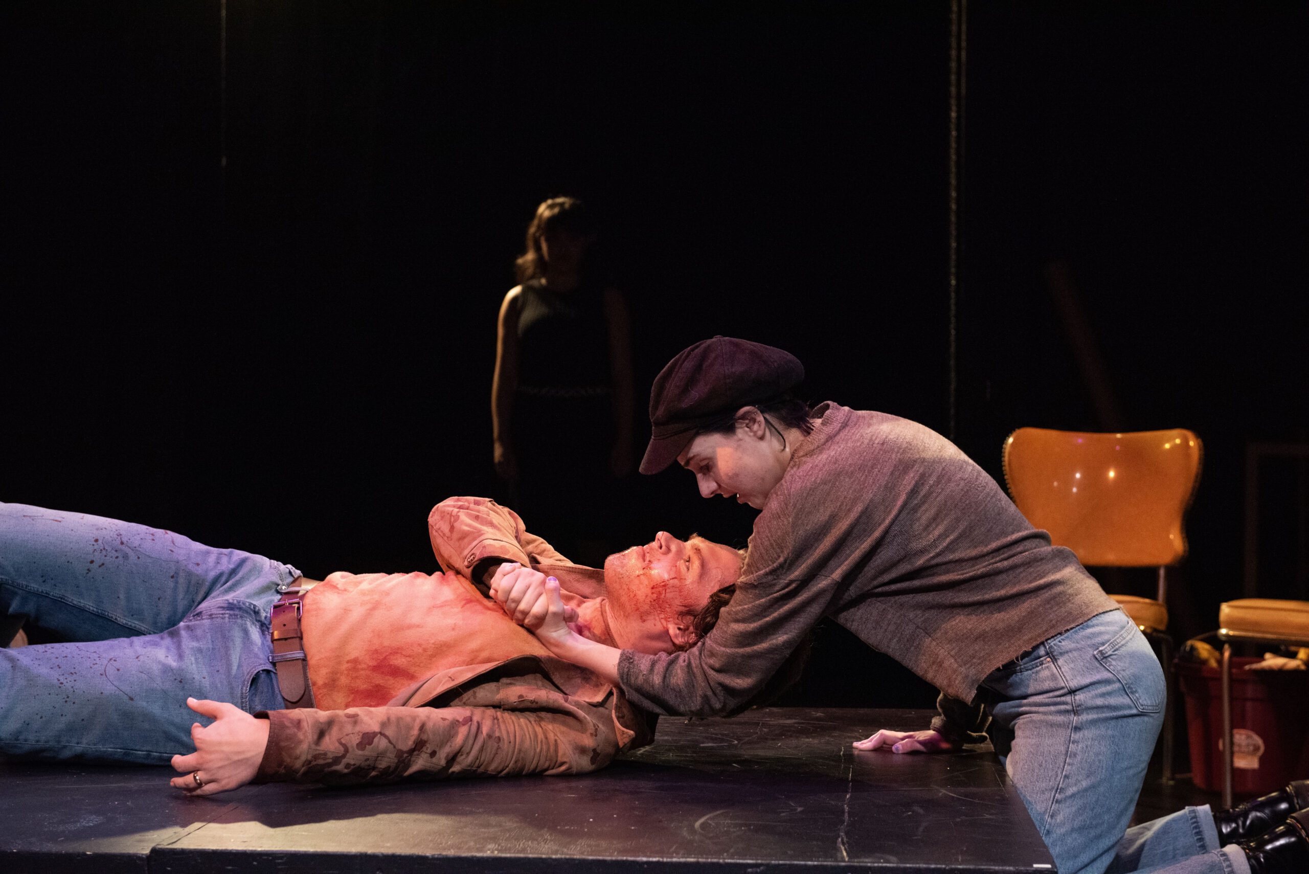 a man holding another man on a stage