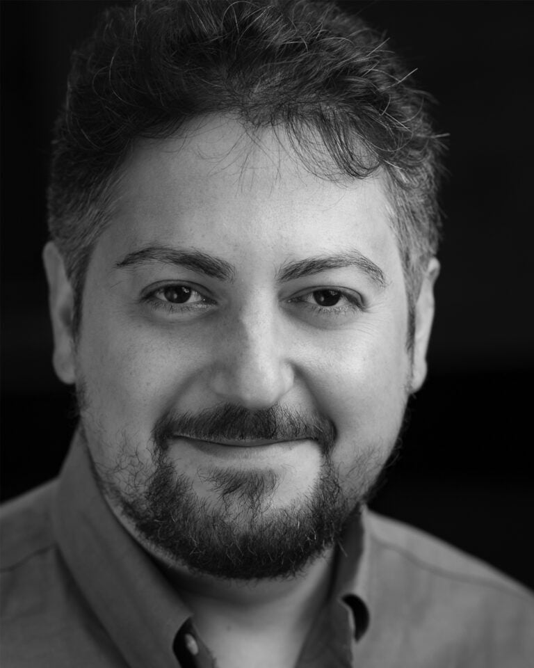 Portrait of Quentin Lee Moore, smiling with a beard.