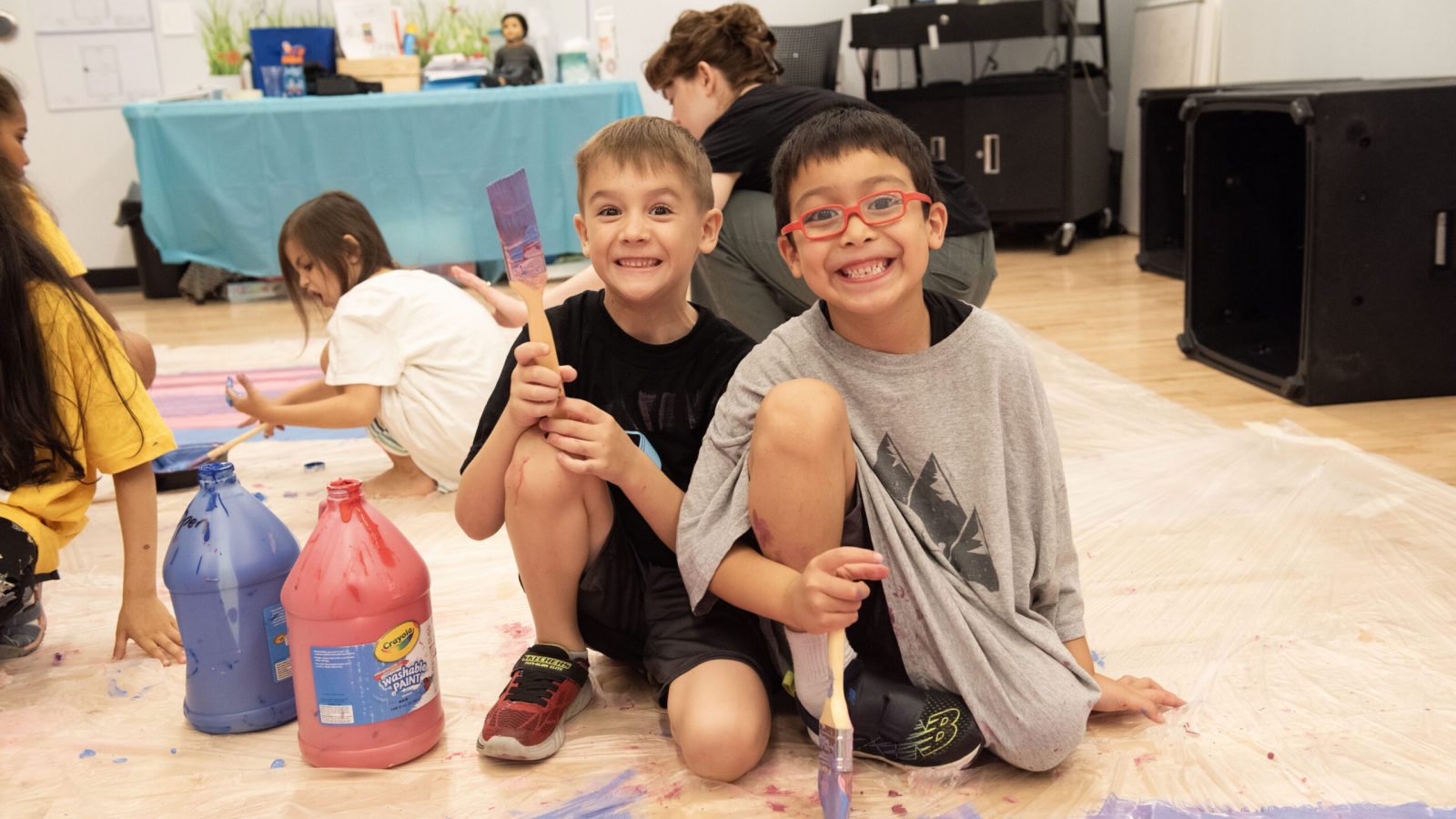 New York Music Photographer a group of kids sitting on the floor with paint on the floor