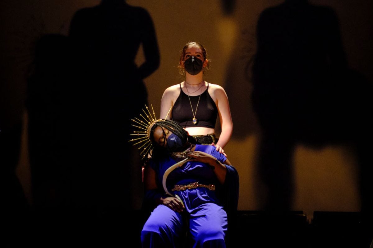 Theater production scene with actors in costumes and masks