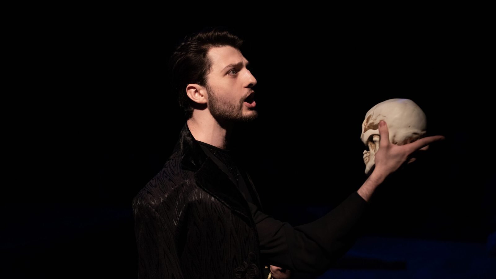 Actor in evening acting classes NYC performing Hamlet with skull.