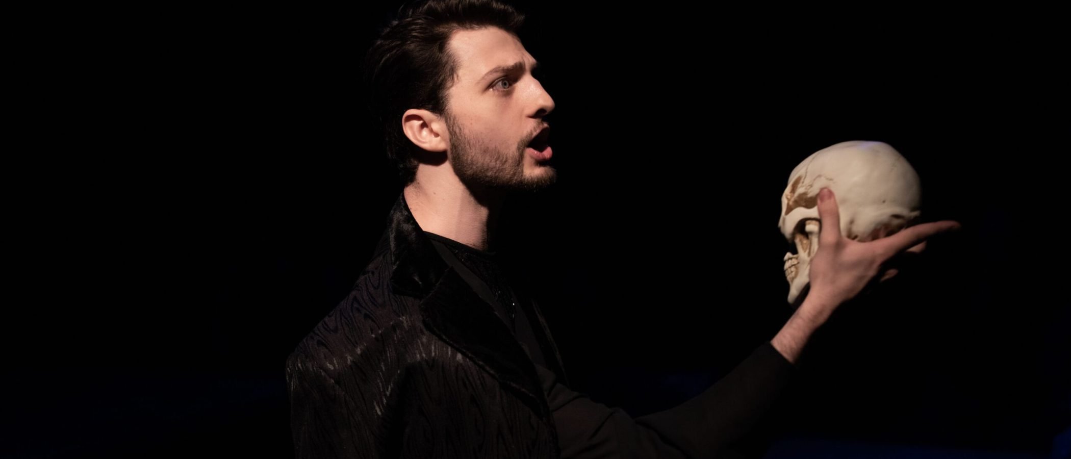 a man holding a skull