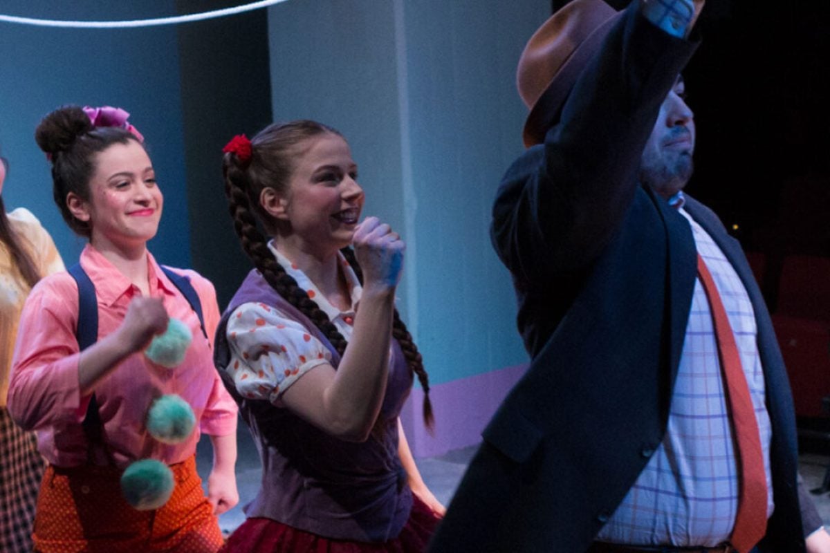 Theater production scene with actors in colorful costumes