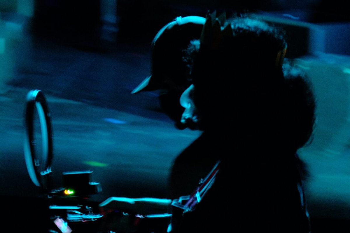 Silhouette of a person with a camera during a production.