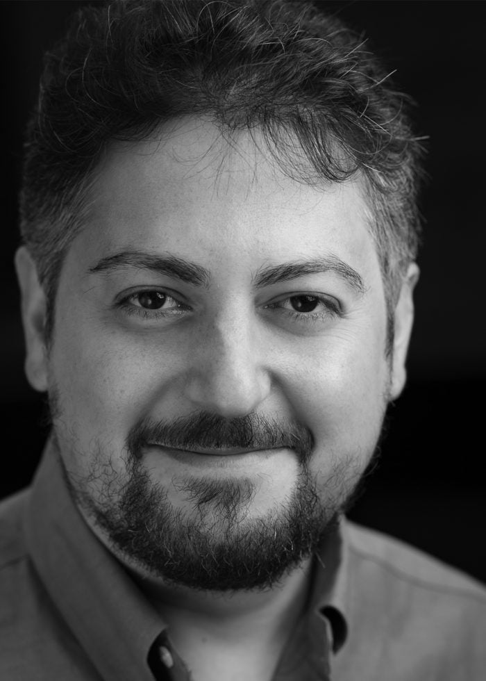 Portrait of Quentin Lee Moore, smiling with a beard.