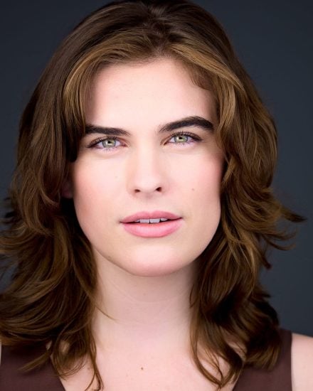 Headshot of Hailey Coudert-Moris with brown hair and striking green eyes.