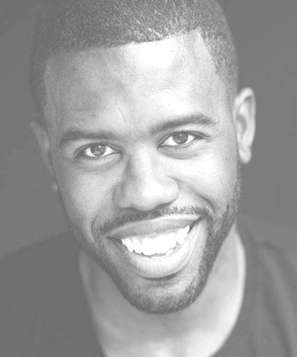 Headshot of Quentin Lee Moore smiling with a beard